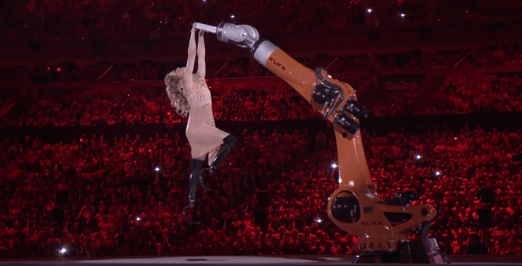 American snowboarder Amy Purdy and robot dance together at the Paralympic opening ceremony.