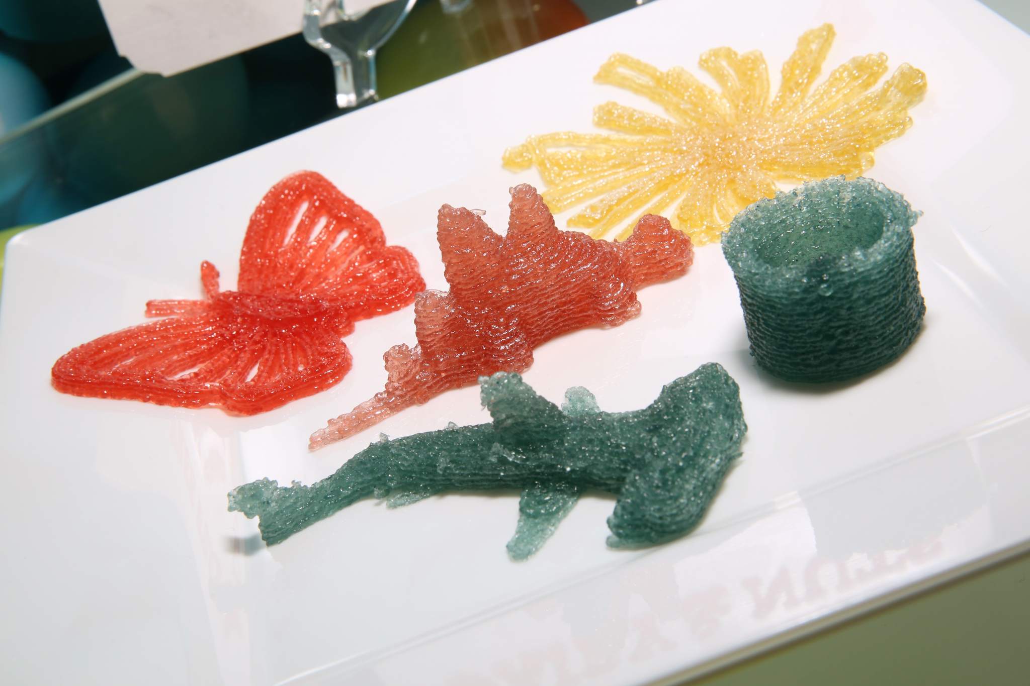 Gummy candy printed in the shape of a butterfly, a stegosaurus and a hammerhead shark. Photo via: Cindy Ord/Getty Images for Dylan's Candy Bar