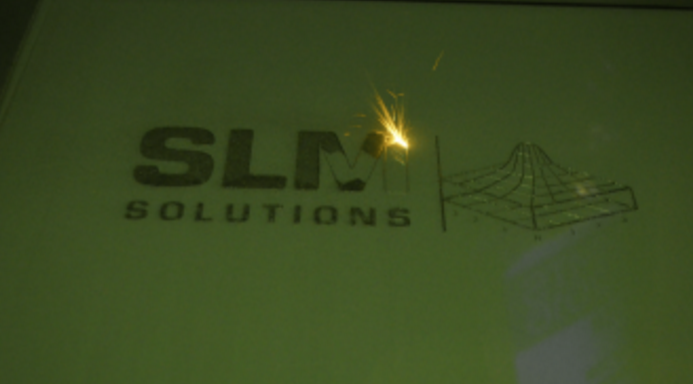 SLM Solutions Logo in Laser. Photo by Michael Petch.