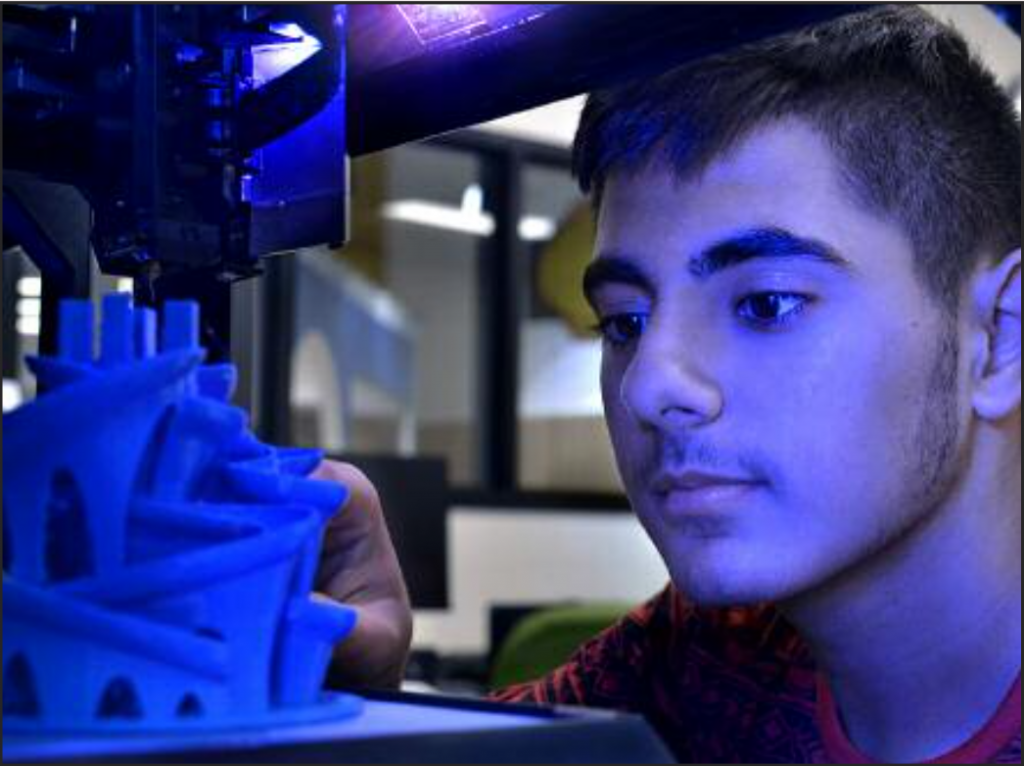 Mohammed Hamed, an MOHS sophomore, watches one of the 3-D printers in action in the school’s new design lab