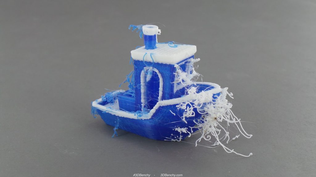 A 3D Benchy boat with some spaghetti-ing on the hull. This is the result of an experiment using 2 different colored filaments, which is an extra challenge to extrusion. Photo via: 3DBenchy on Flickr