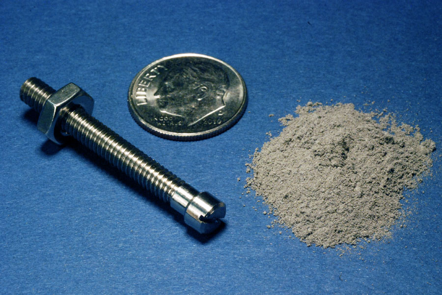 'Finished 1.8 gram titanium bolt made from 1.8 grams of gas atomized titanium powder' next to the metal in powder form. Photo via: Ames Laboratories 