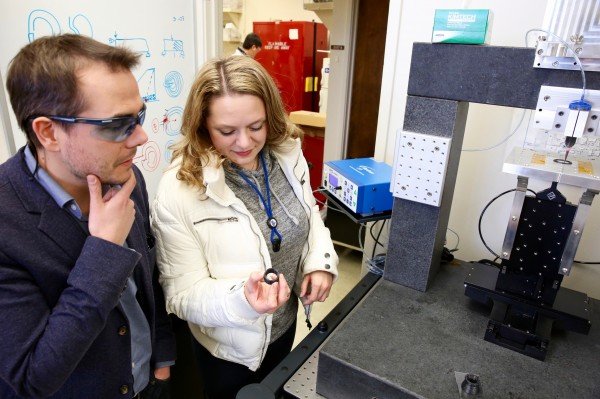James Lewicki and Jennifer Rodriguez looking at a 3D-printed carbon fiber part created using their technique. Photo via Kate Hunts/LLNL.
