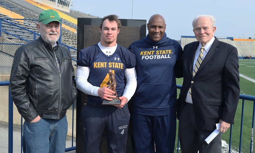 Retired Coast Guard Lieutenant Jim Loomis with Nick Holley, coach Paul Haynes, and former teammate of Rittichier's Allan Kaupinen. Photo via Kent State Sports News.