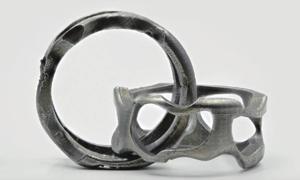 Interlocking steel loops after supports have been dissolved. Photo via 3D Printing and Additive Manufacturing journal Volume 4, Number 1, 2017