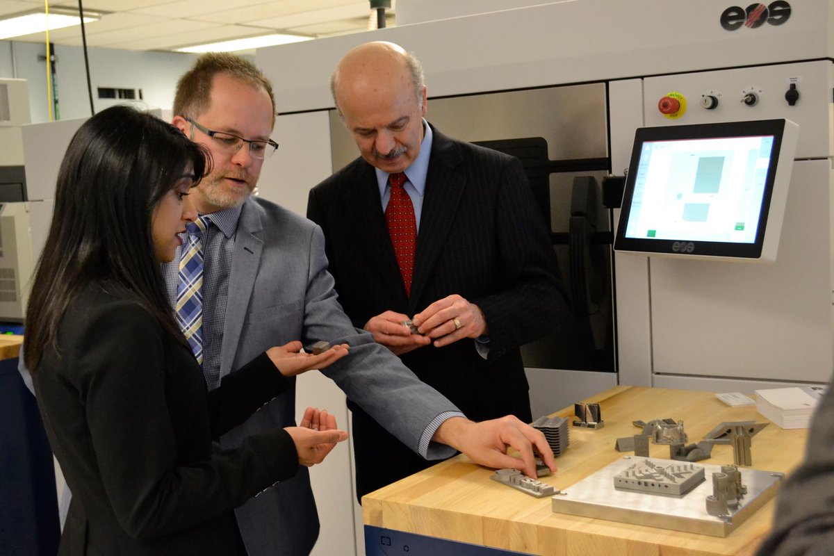 The two MPs, Chagger and Moridi, examine metal 3D printed parts. Photo via University of Waterloo. 