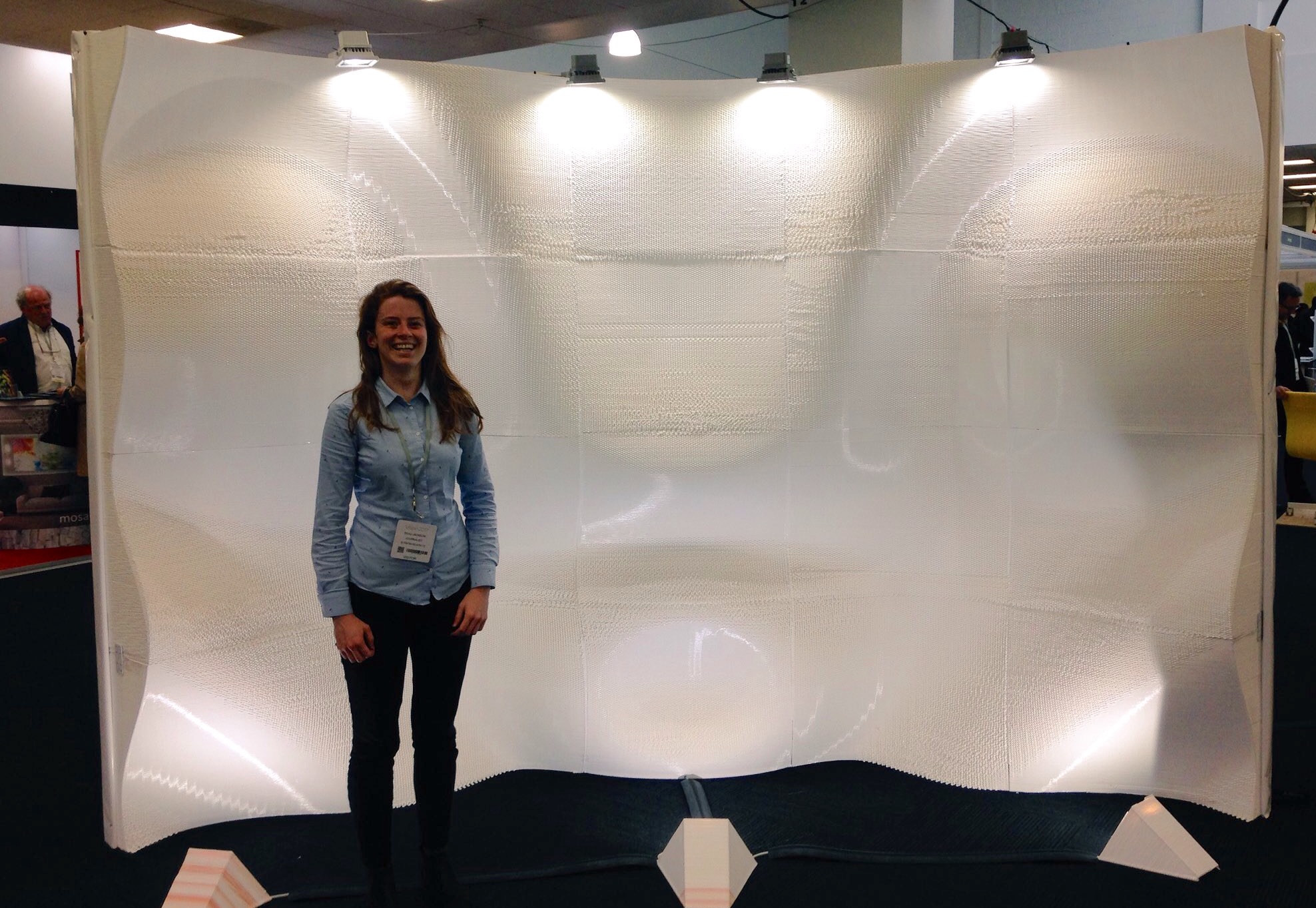 3D Printing Industry journalist Beau Jackson stands with WASProject's 3D printed wall at Vision 2017 in London, UK. Photo by Nicola Schiavarelli