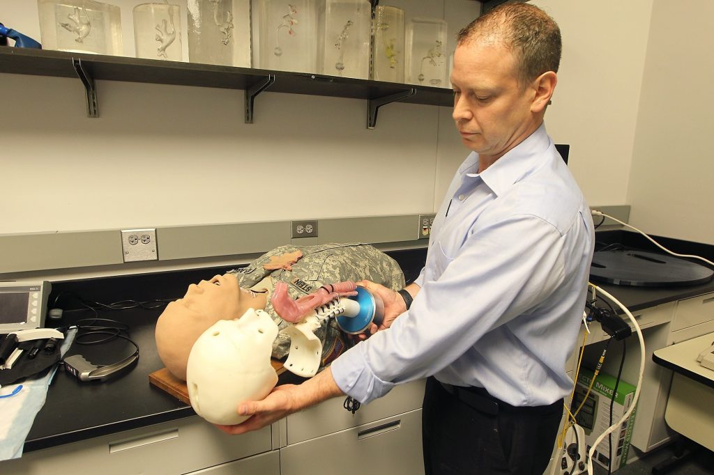 The University of Minnesota's Troy Reihsen shows 3D printed model used to train medical students. Photo via Stratasys