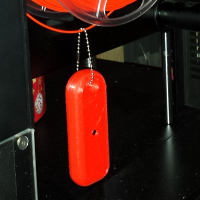 Mister Screamer primed hanging from a filament spool. Photo via Hackaday. 