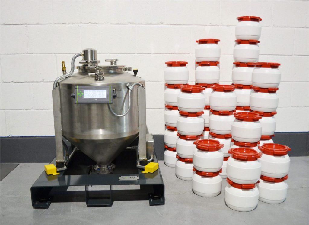 An LPW PowderTrace hopper and stack of tubs containing metal powder. Photo via LPW Technology