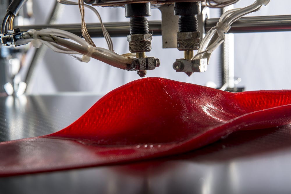 3D printing Tailored Fits custom insoles. Photo via Materialise