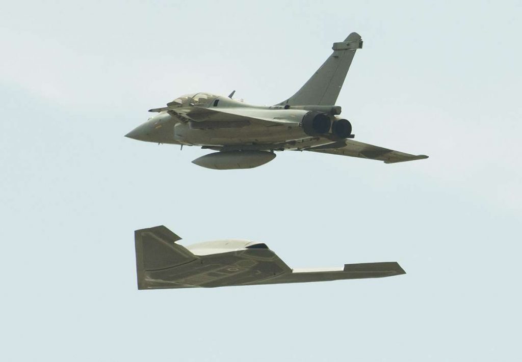 A DARPA Unmanned Combat Aerial Vehicle (UCAV) accompanied by a Dassault Rafale fighter jet. Photo via AP Images