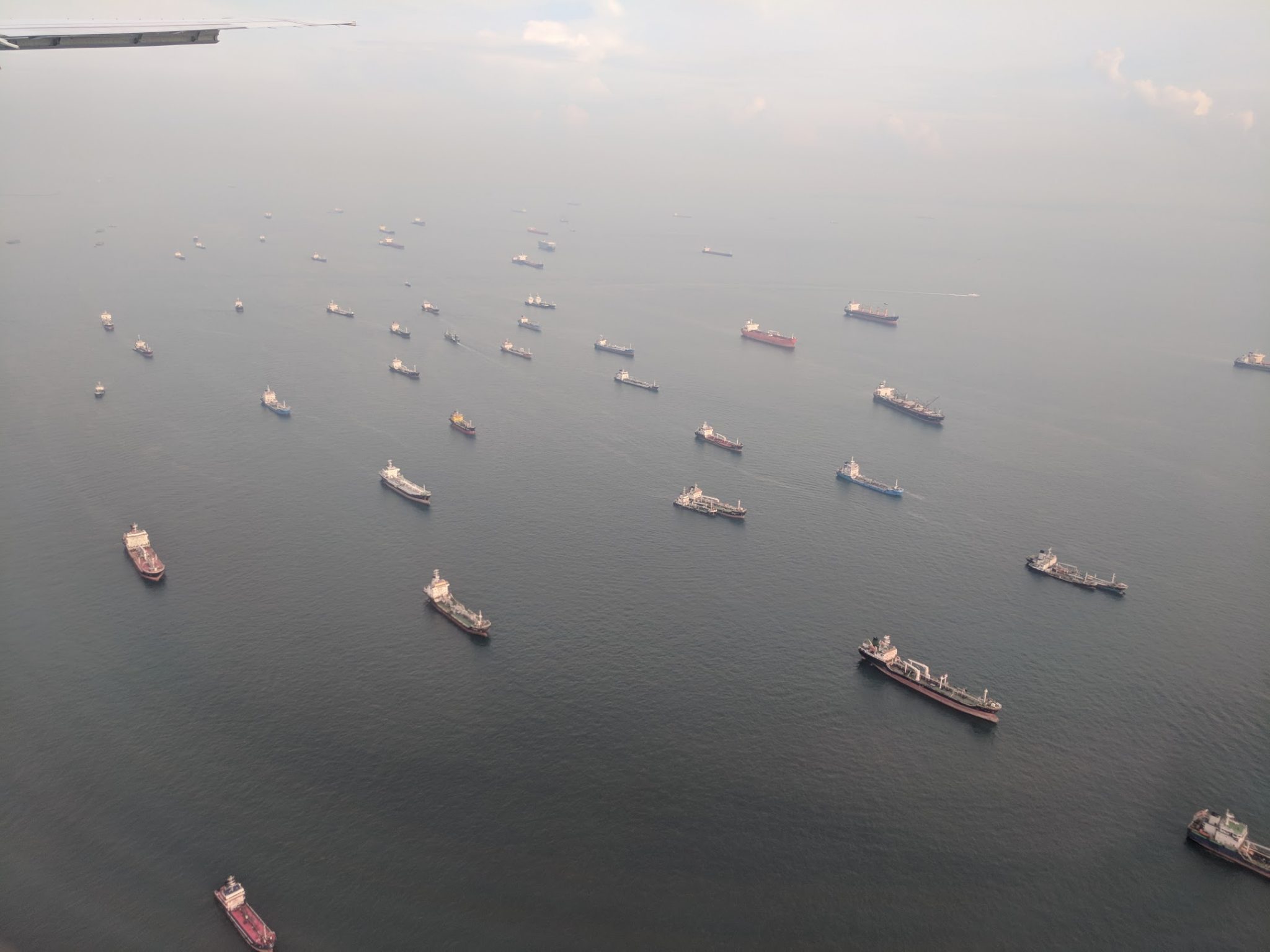 Cargo ships in the sea off the coast in Singapore. Photo by Michael Petch.