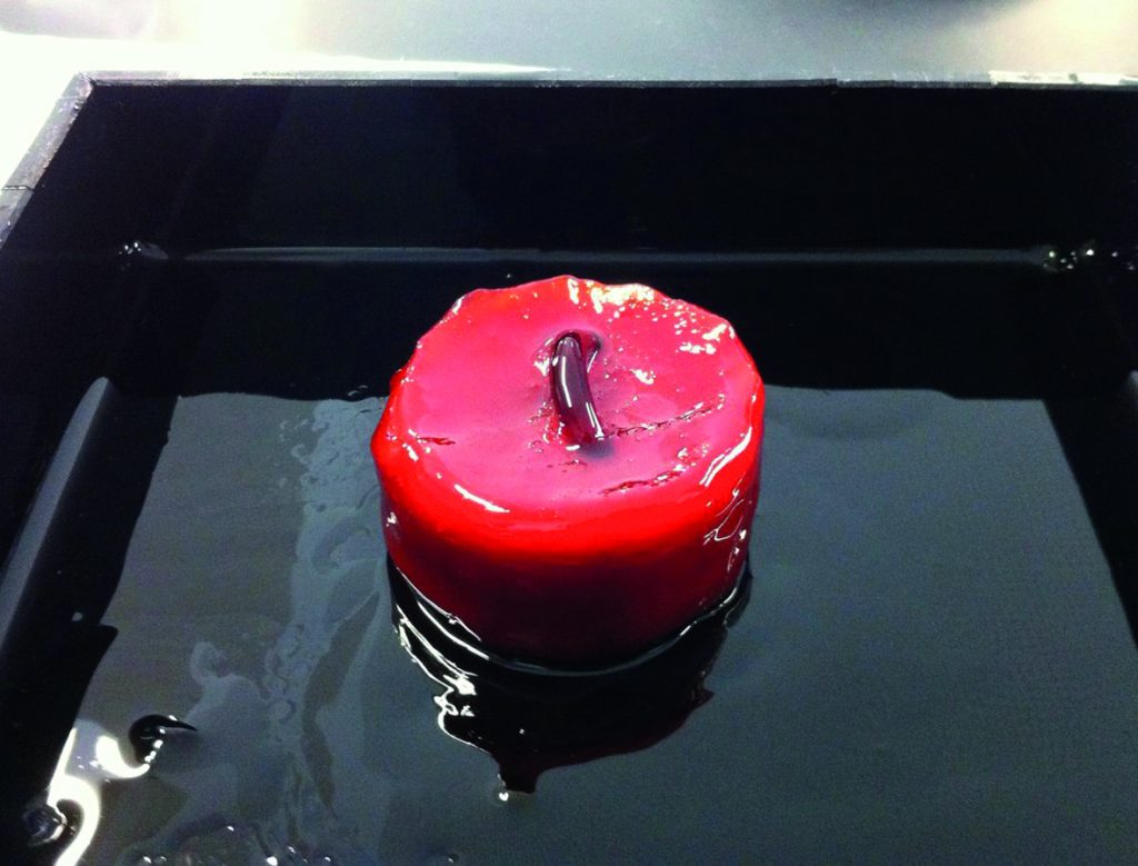 A wax like block forms around free-floating solid parts that liquefies at room temperature. Photo via Fraunhofer ILT
