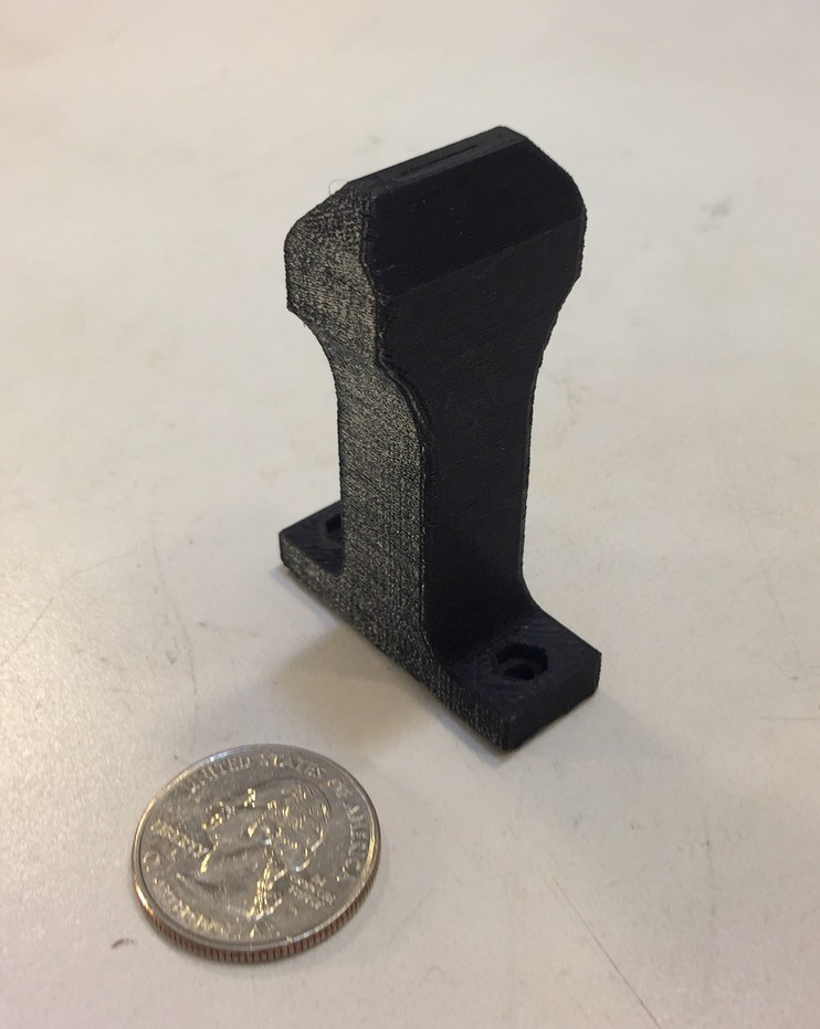 The finished 3D printed PETG slot die with quarter for scale. Photo via Beeker, Pringle and Pearce