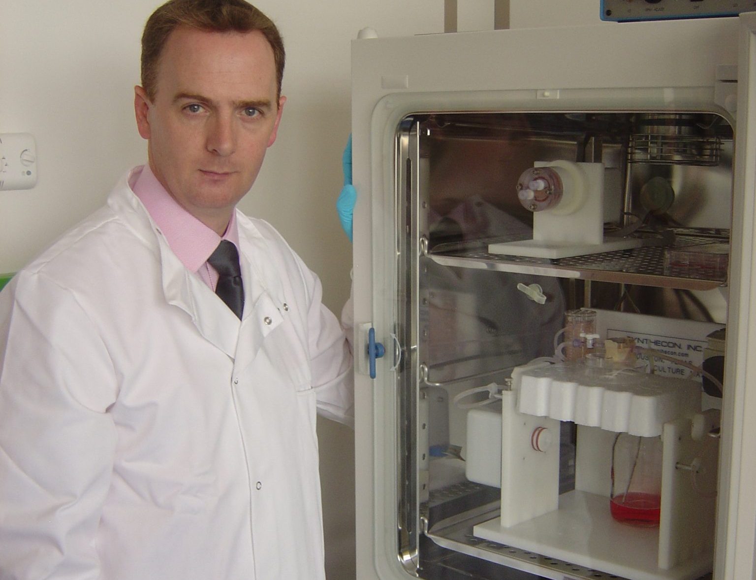 Prof Colin McGlucklin with a bio-printer at CTI Biotech. Photo via CTI Biotech.