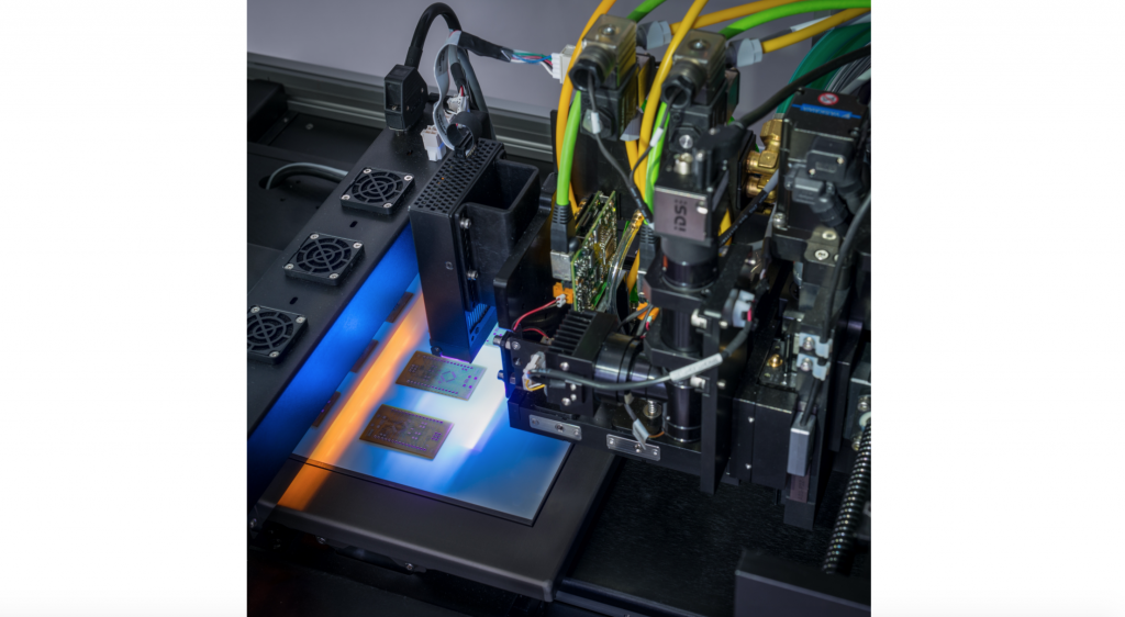 The DragonFly 2020 Pro 3D printing PCBs. Photo via Nano Dimension