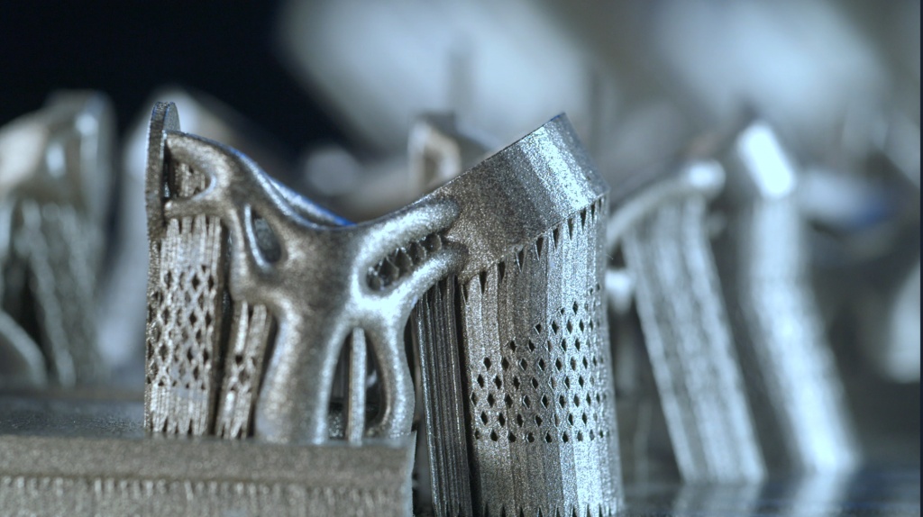 Metal components, 3D printed in a Sintavia machine on a build plate.  Photo via Sintavia.