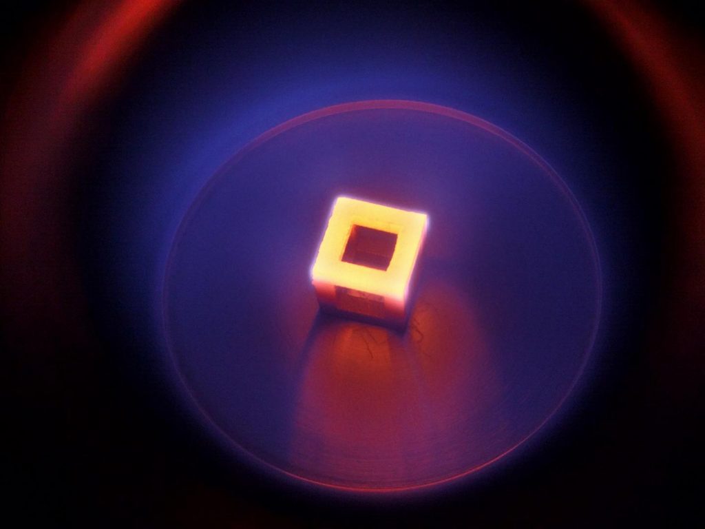 A hollow, 3D printed titanium cube. Heated for diamond coating. Photo via RMIT University