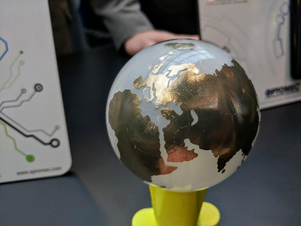 Optomec demonstrated 3D printed silver from electronics at AMUG 2018. Photo by Michael Petch.