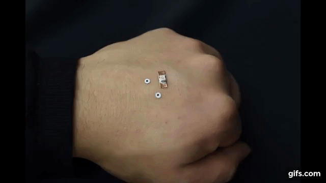 Before the electrical or cell-laden ink is deposited, small markers are placed onto the skin. Clip via College of Science and Engineering, UMN on YouTube