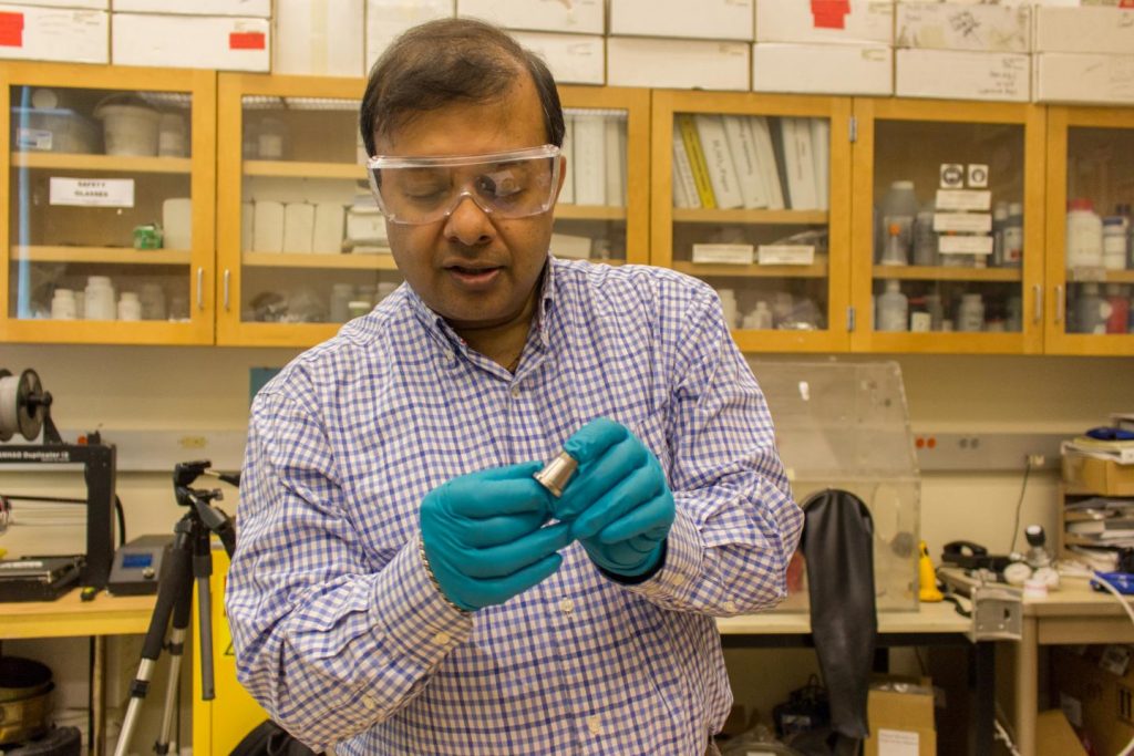 WSU Professor Amit Bandyopadhyay holds a 3D printed sample of Inconel 718 and copper. Photo via WSU