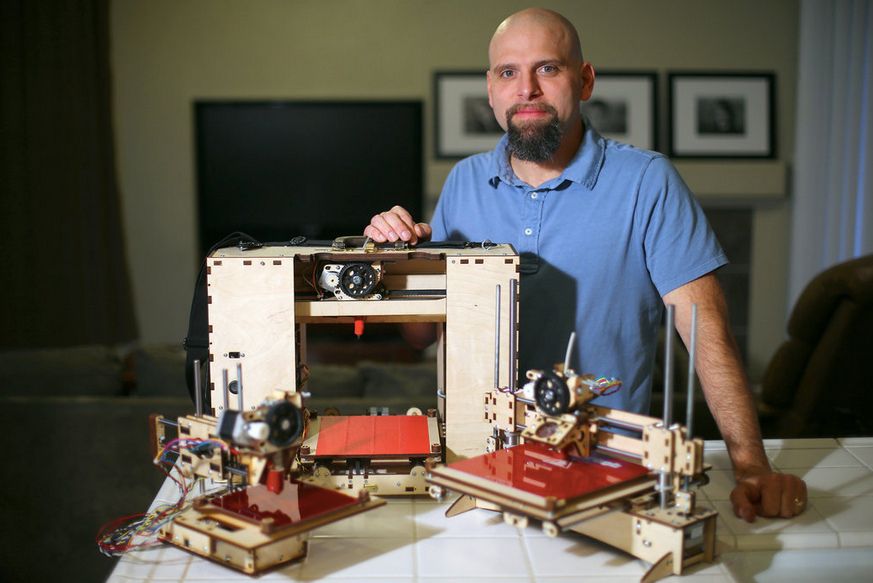 Brook Drumm and some early 3D printers. Photo via Printrbot.
