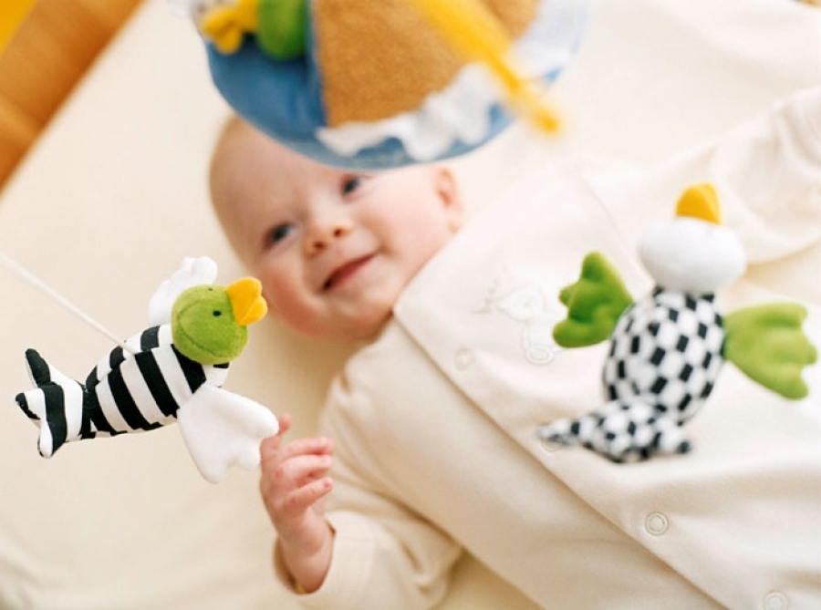 Baby looking at standard stuffed animals for visual stimuli. Photo via Pinterest.