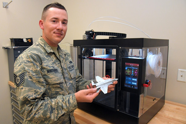Tech Sgt. Scott Matthews, holding a 3D printed F-35. Photo by Todd Cromar