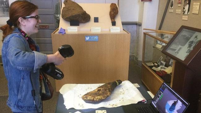Virginia Commonwealth University student Rebecca McGovern scans the Smithfield ham in the Isle of Wight County Museum Thursday. Photo via Daily Press/Courtesy of Bernard Means.