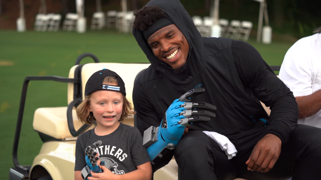 Cameron Haight and his hero, Carolina Panthers quarterback, Cam Newton. Photo via Riot Report