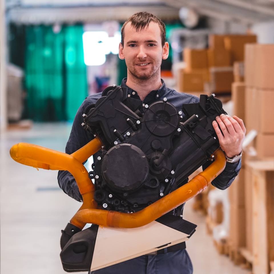 Arturs Gribs, Photocentric’s 3D Optimisation Manager with the fully assembled prototype motorbike engine, 3D printed in the LC Maximus. Image via Photocentric.