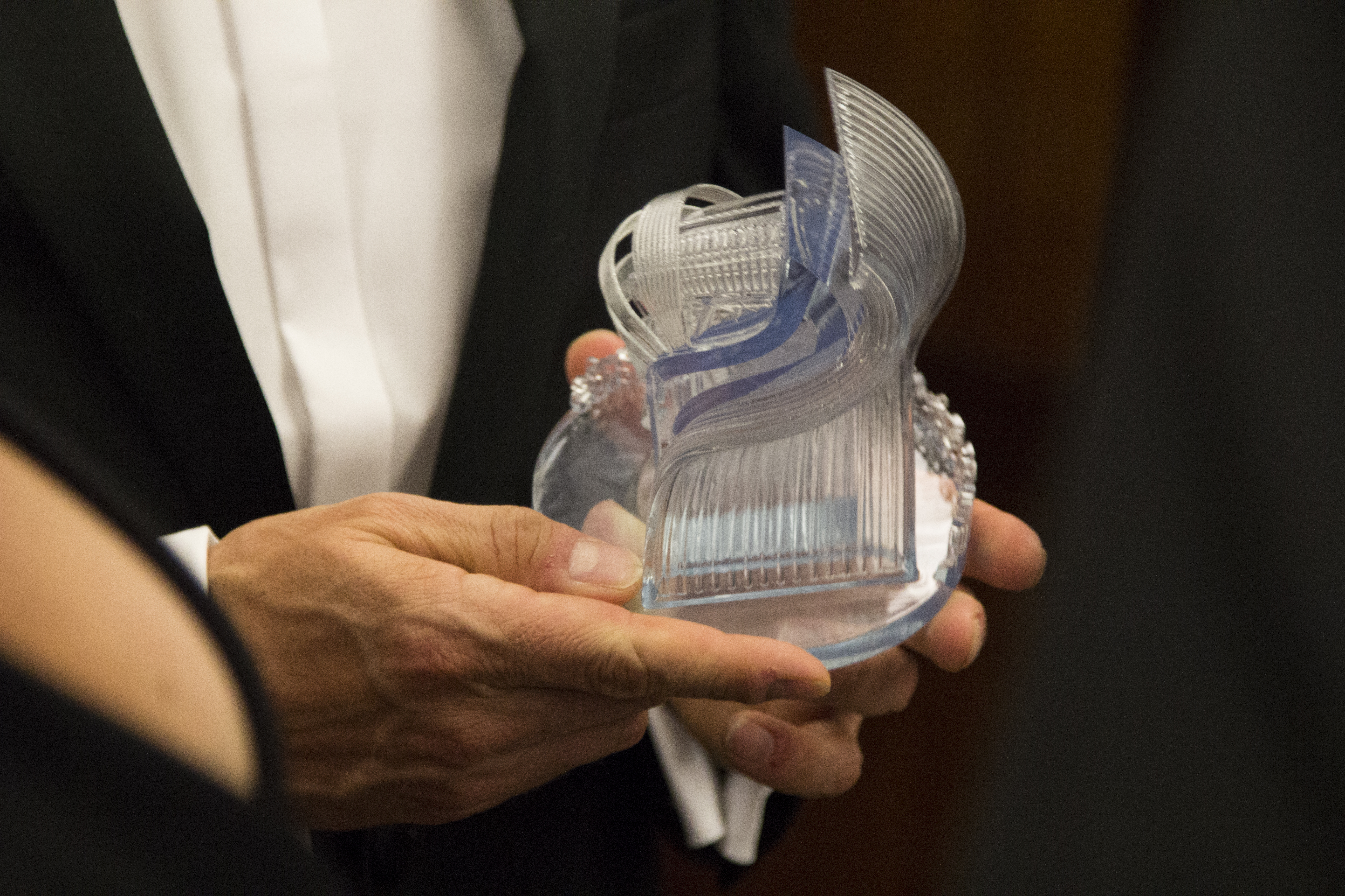 The 2018 3D Printing Industry Awards trophy in the hands of one of last year's winners.
