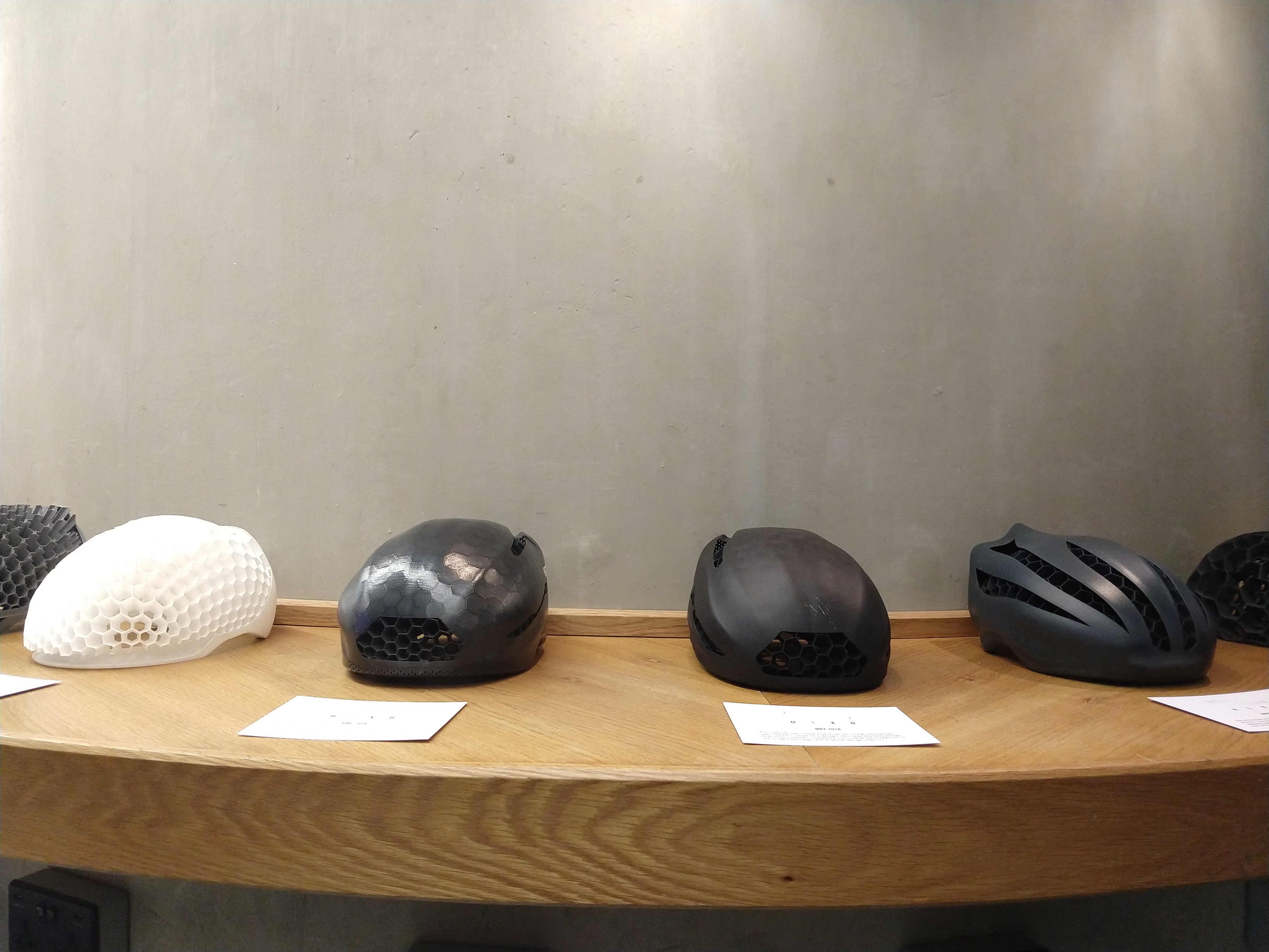 Different iterations of the Hexo Helmet in various development stages on display at the event.