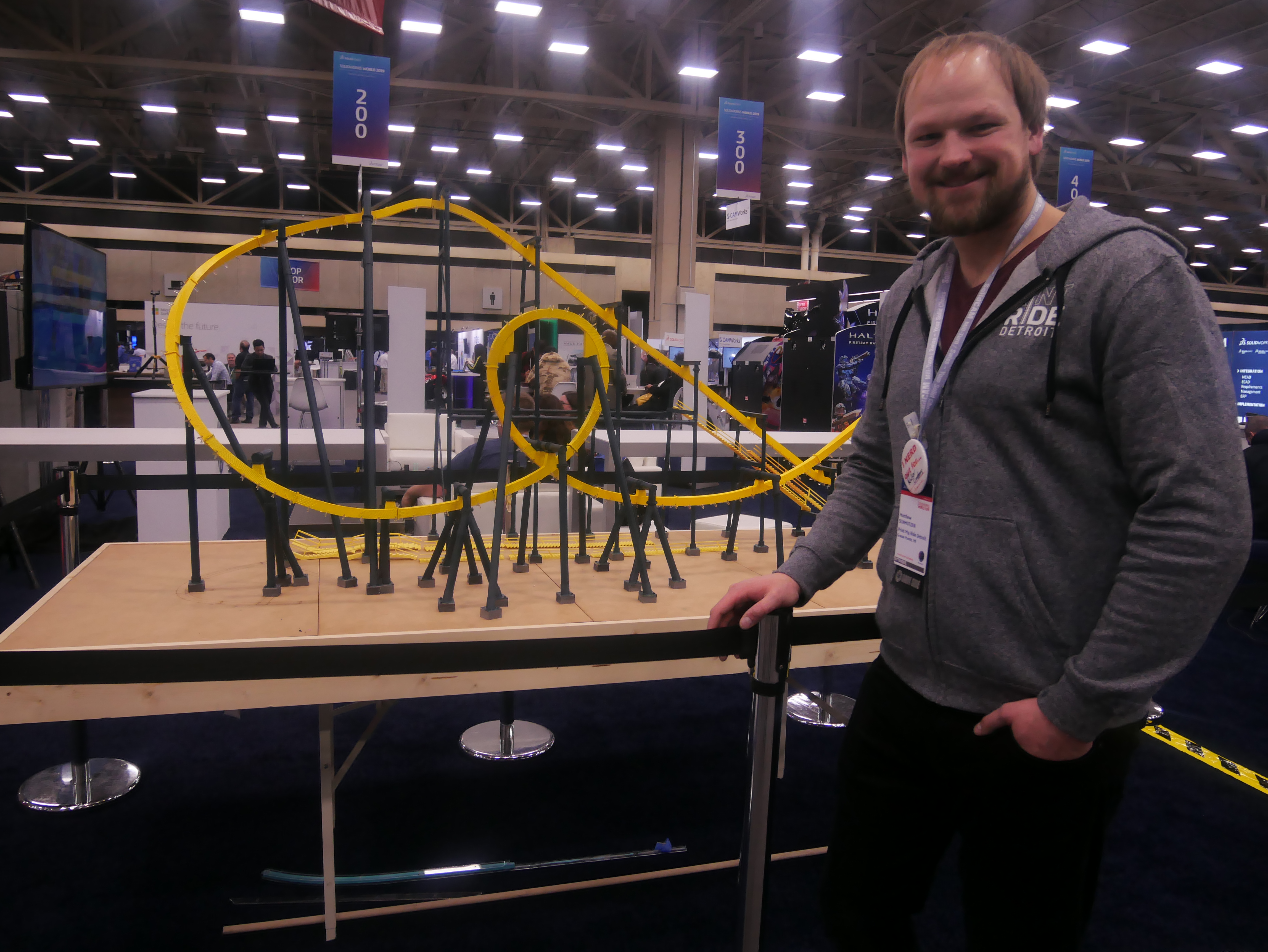 Matt Schmotzer next to a 3D printed rollercoaster model. Photo by Tia Vialva.