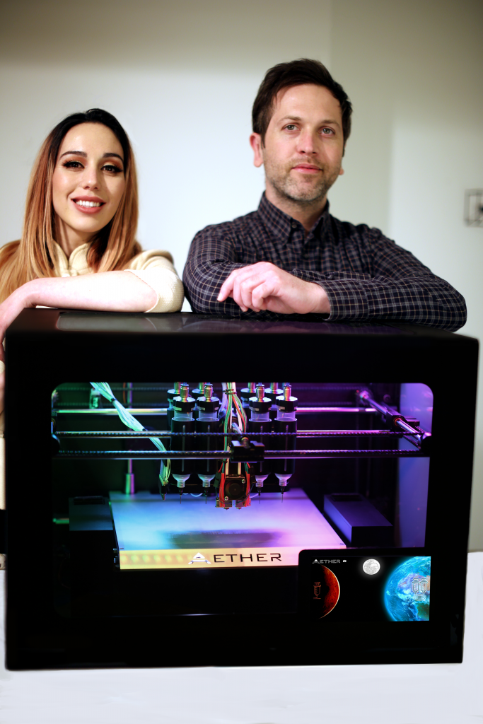 Marissa Buell, Aether Director of Engineering and Ryan Franks, Aether CEO with the Aether 1 3D Bioprinter. Photo via Aether