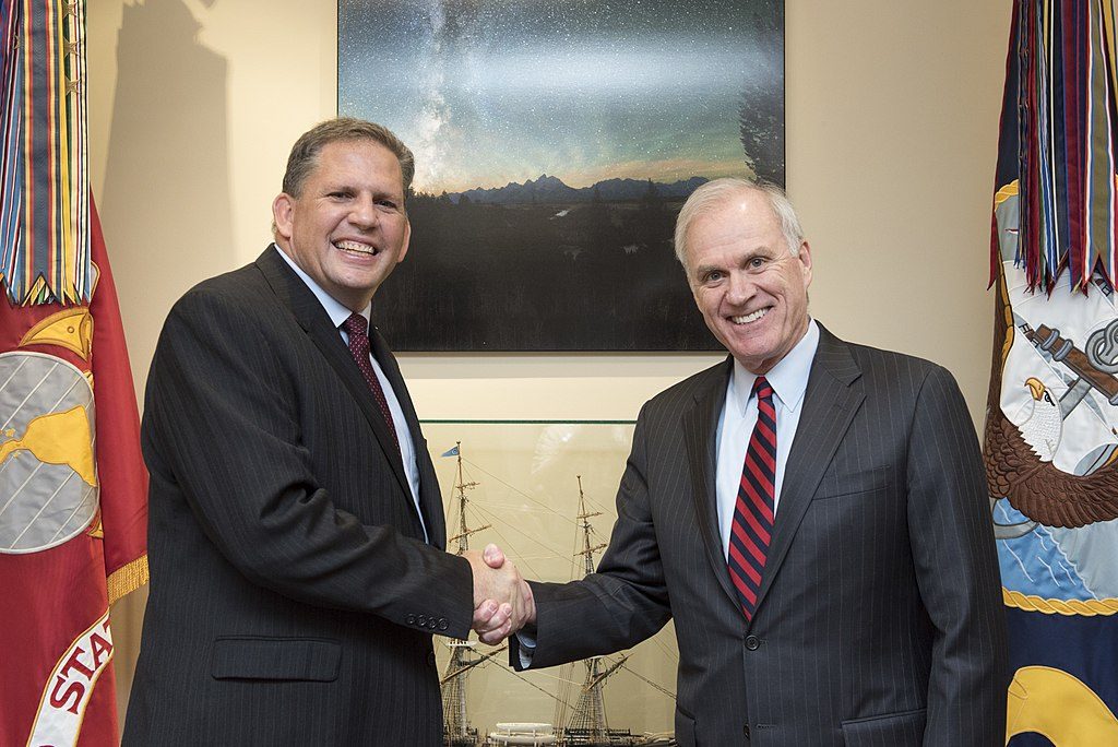 James F. Geurts, left, greets Secretary of the Navy Richard V. Spencer before formally swearing in as assistant secretary of the Navy for research, development, and acquisition (RD&A) at the Pentagon in Washington. Photo via Wikimedia Commons/U.S. Navy 