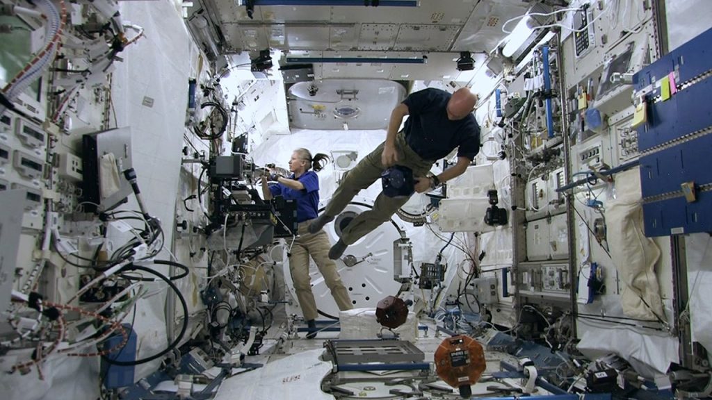 Crew working inside the International Space Station. Photo via NatGeo/ISS: 24/7 ON A SPACE STATION