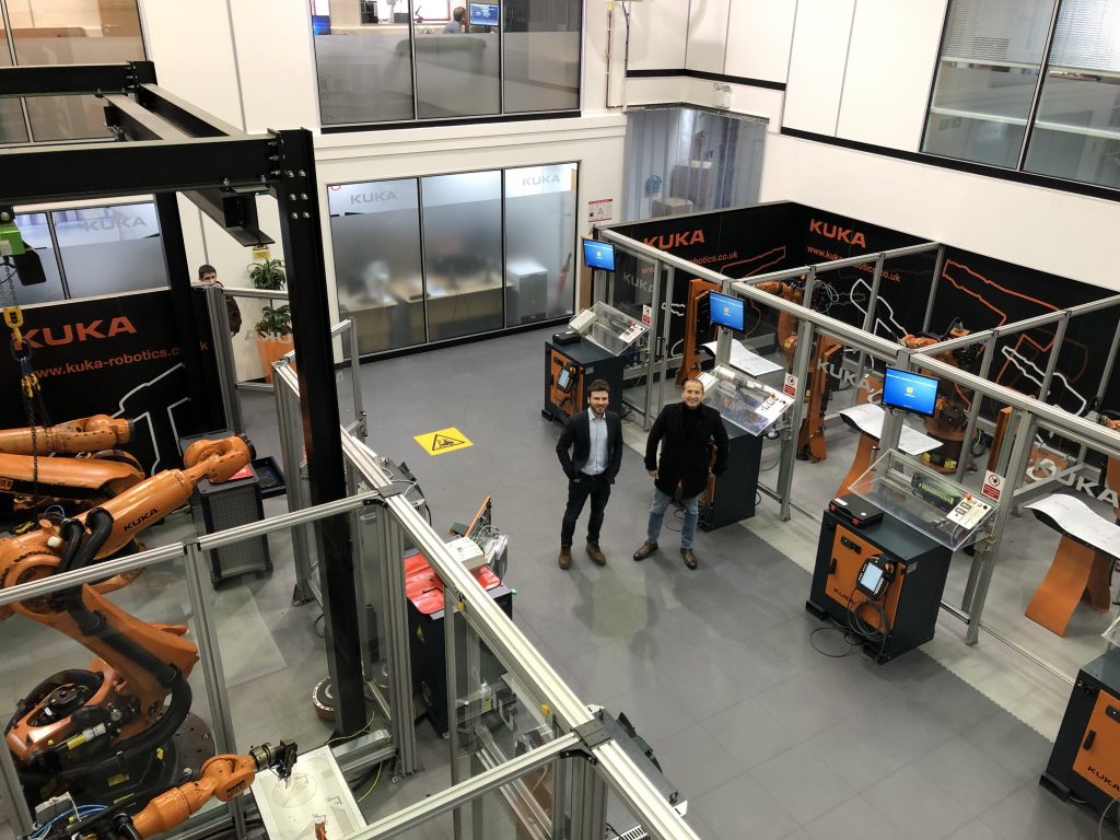 Left: Daghan Cam, Ai Build stands with, Right: Edouard Baaklini, 3DVinci Creations amidst a facility of KUKA-operated AiMakers. Photo via 3DVinci Creations