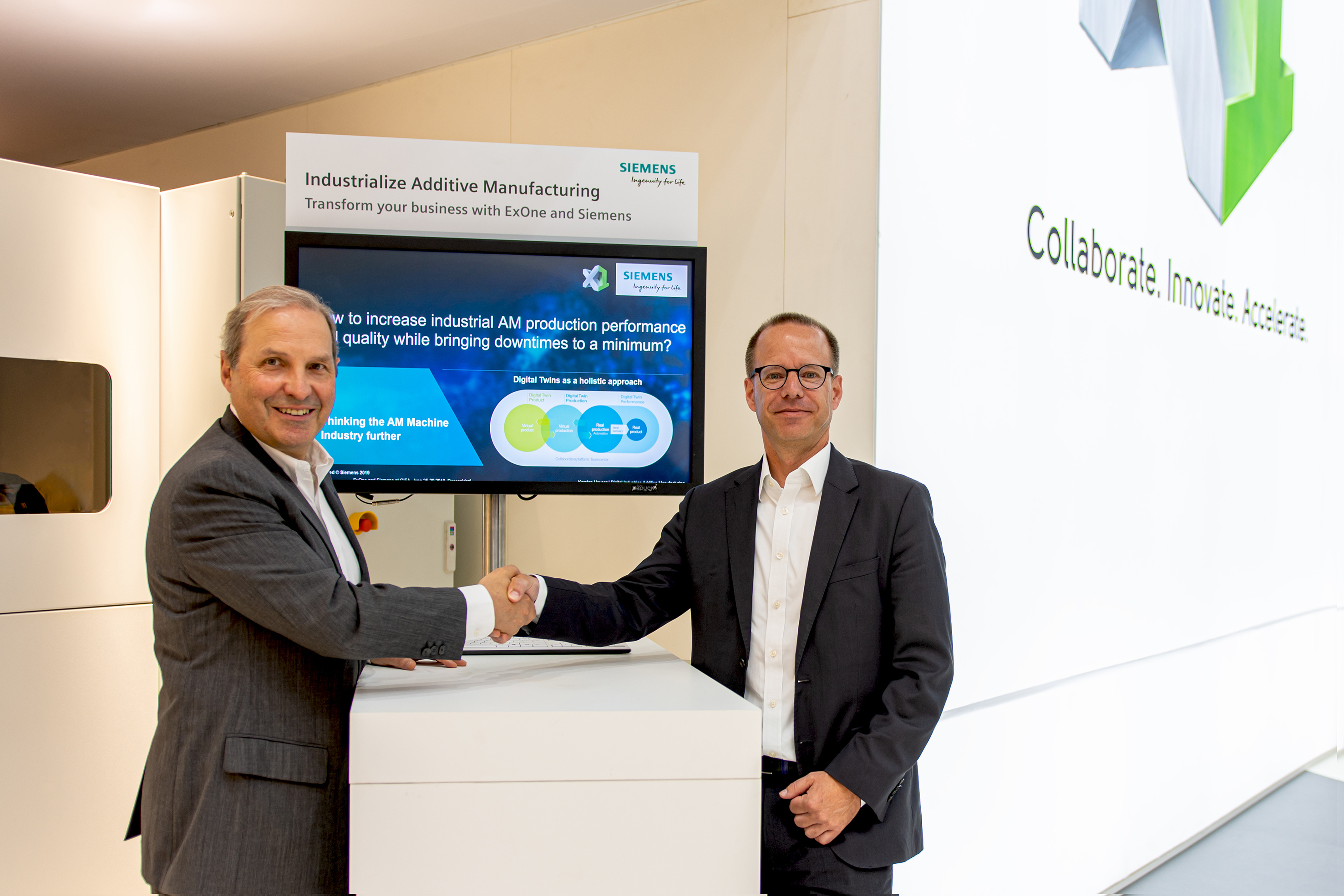 (Left) John Hartner, CEO of ExOne and Dr. Karsten Heuser, Vice President of Additive Manufacturing at Siemens Digital Industries. Photo via ExOne.