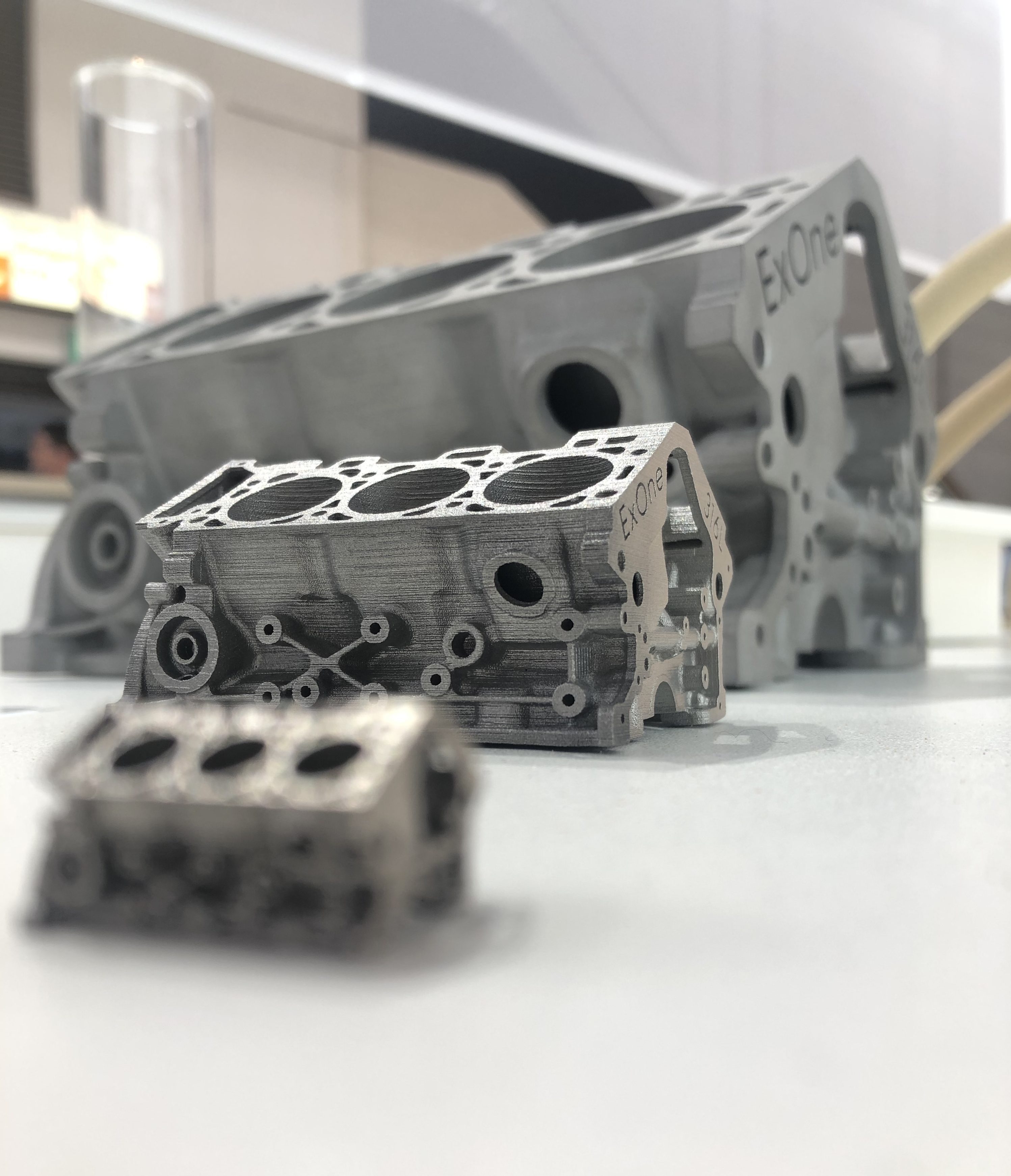 3D printed engine blocks on display at the GIFA show. Photo via ExOne.
