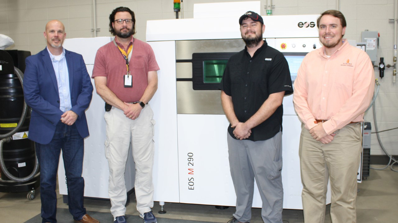 Team members from NCAME, Huntsville City Schools, and EOS worked together to bring online the district’s second industrial 3D printer at Grissom High School. Photo via Auburn University.