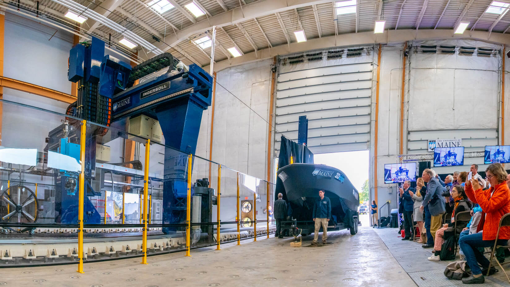 The world's largest polymer 3D printer and 3D printed boat. Photo via UMaine.