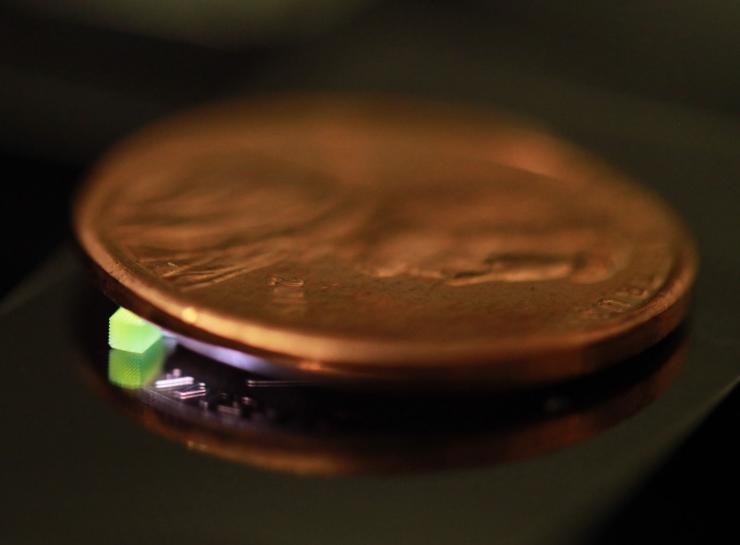 Penny for scale: 2.20 mm × 2.20 mm × 0.25 mm cuboid with submicrometer lattice feature 3D printed using high-speed two photon lithography from CUHK and LLNL. Photo via Georgia Tech