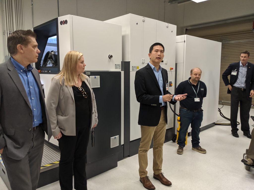 Quan Lac, Head of Additive Manufacturing Americas for Siemens Gas & Power, giving an overview of Materials Solutions’ U.S.-based EOS M400-4. Photo by Dayton Horvath for 3D Printing Industry