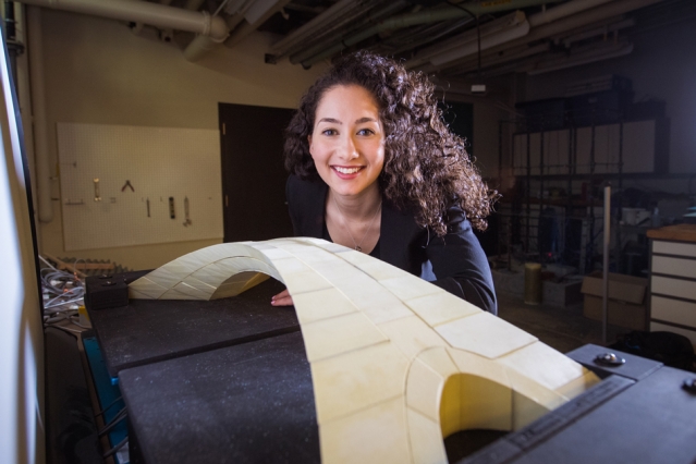 Karly Bast beside the 3D printed model of da Vinci's bridge design. Photo via MIT.