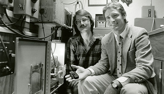 Carl R. Deckard and Dr. Joe Beaman with one of the first SLS devices. Photo via Ralph Barrera.