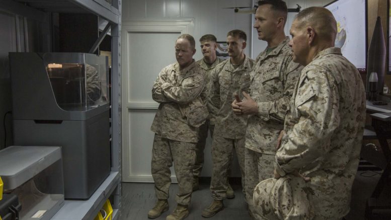 Armed forces observing a 3D printer. Photo via Marine Corps.