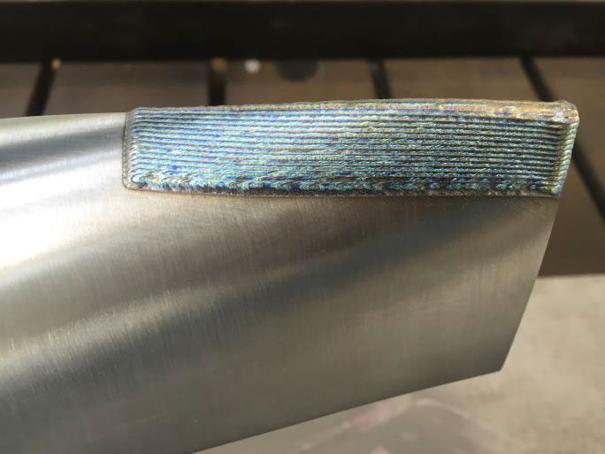 Repairing a turbine blade using laser deposition welding. Image via CHIRON.