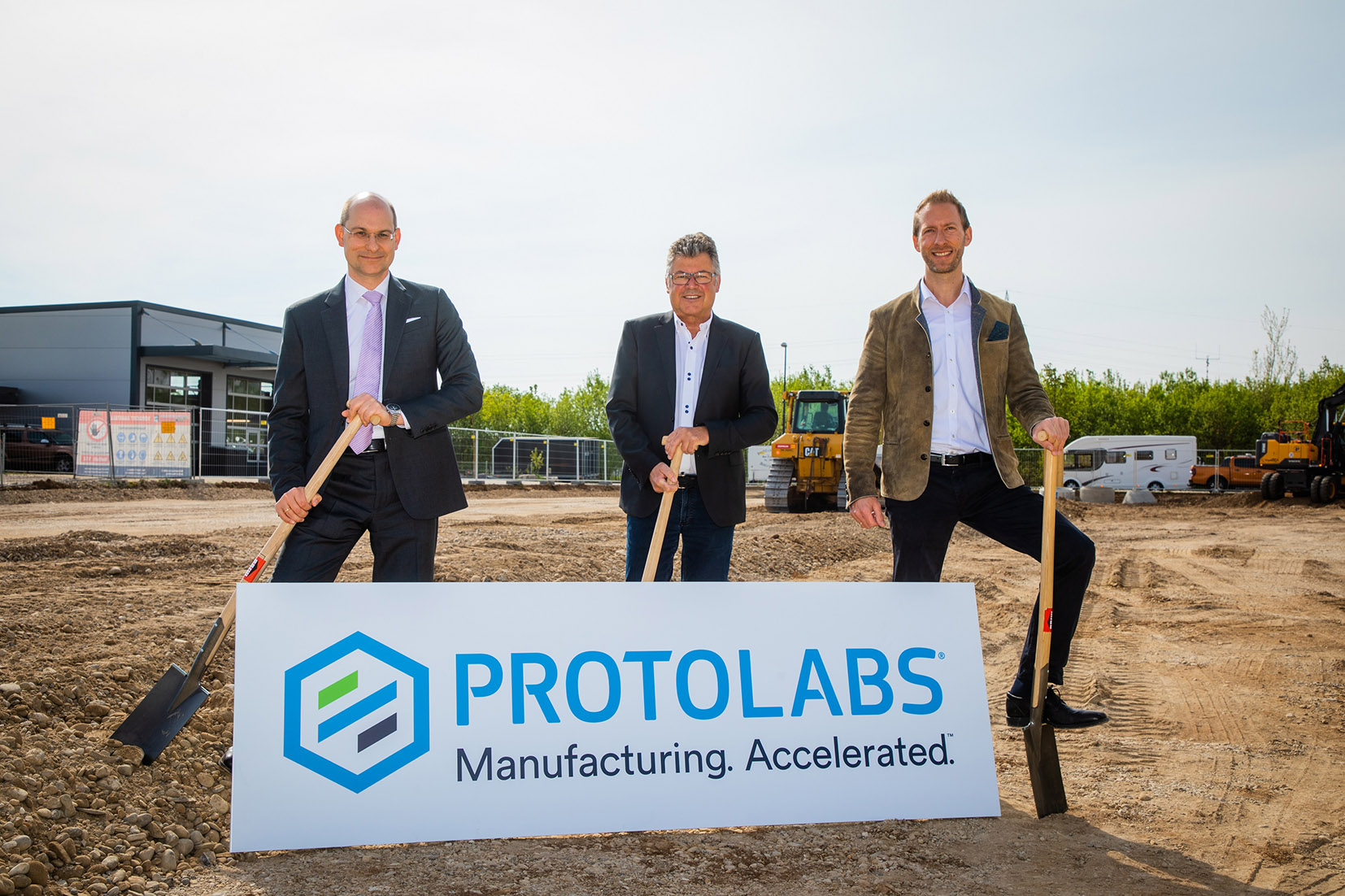 Featured image shows construction getting underway at Protolabs' new site (From left) Michael Meier (Protolabs), Edwin Klostermeier (Mayor of Putzbrunn) and Daniel Cohn (Protolabs). Photo via Protolabs.